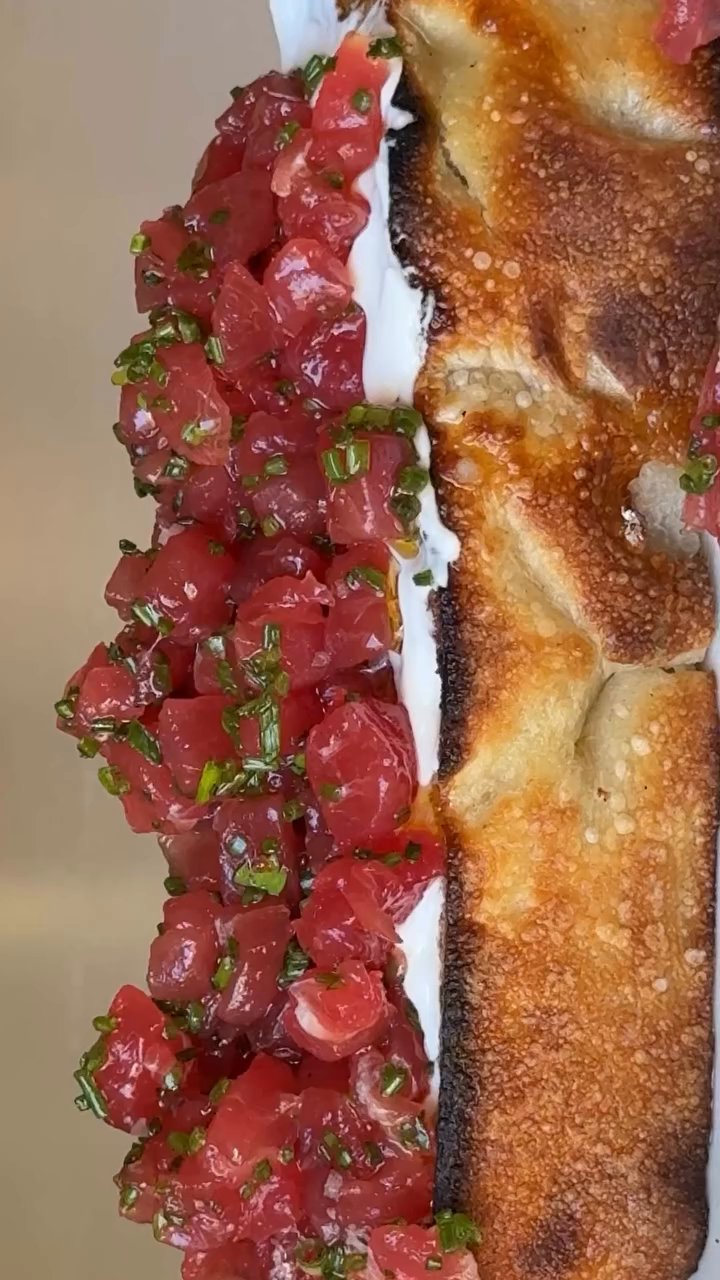 Event flyer: Vibrant dish showcasing tartare atop crispy crust